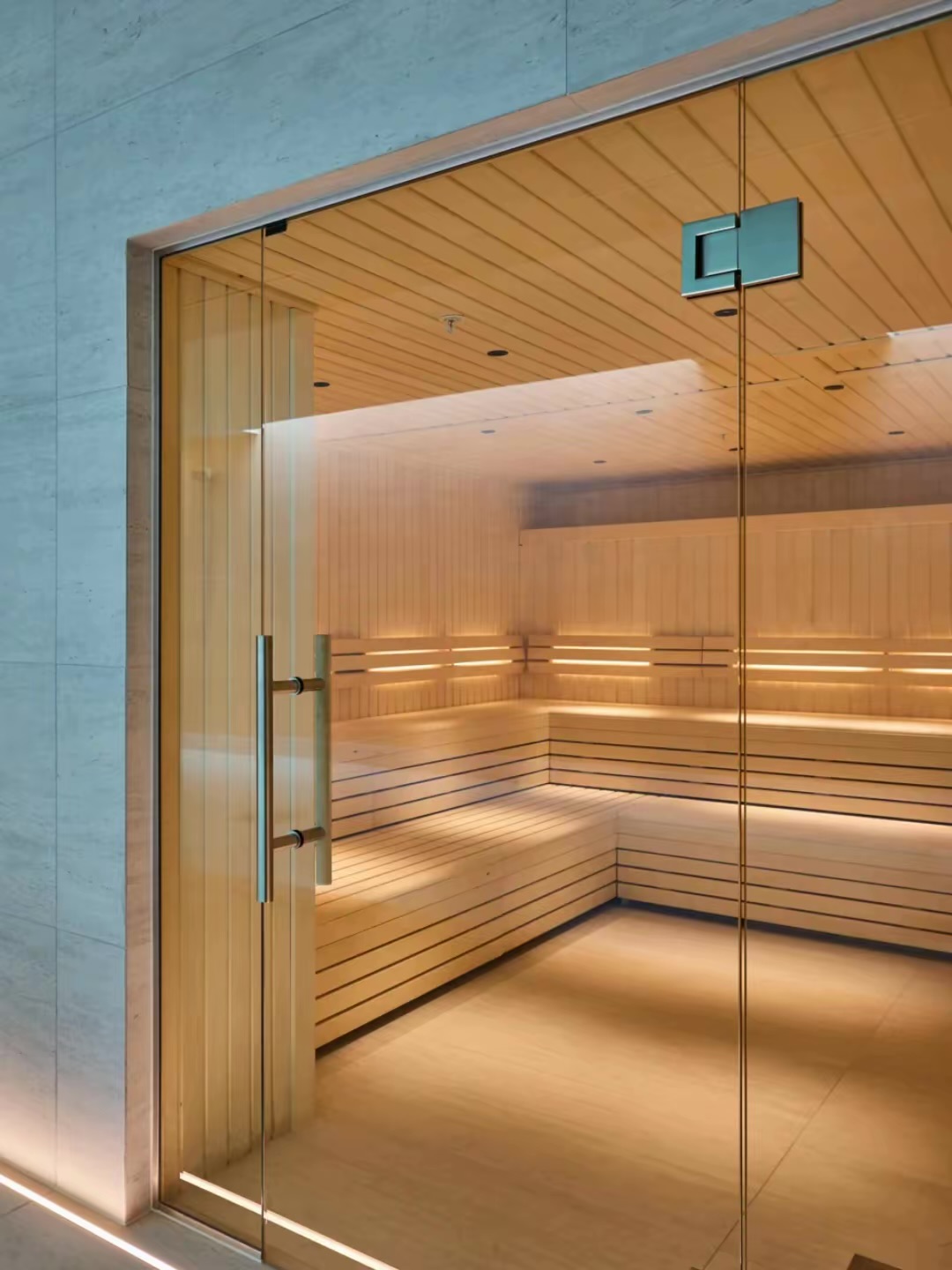 Glass-fronted sauna with wooden benches