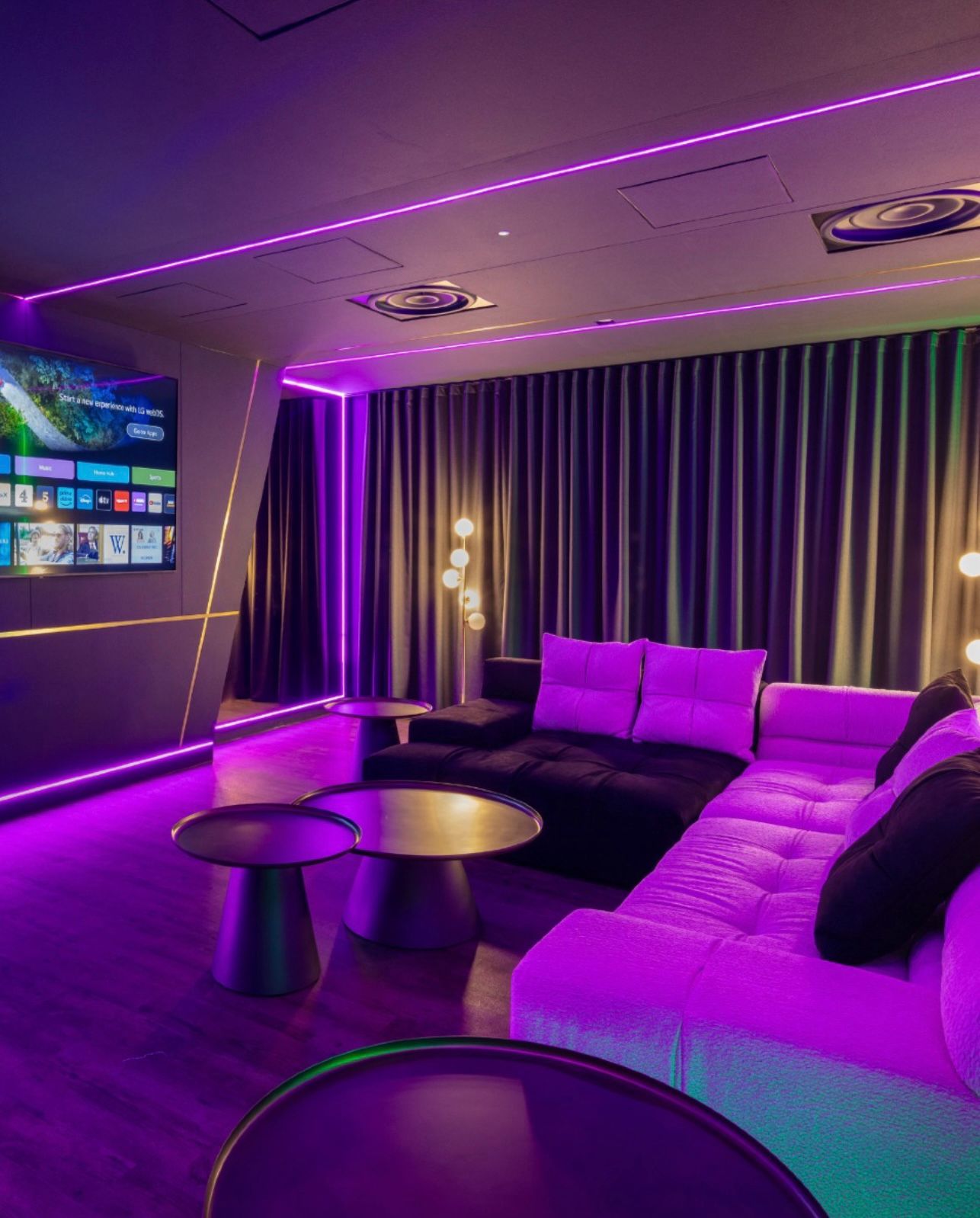 Residents' cinema with a large screen, sofas and feature lighting