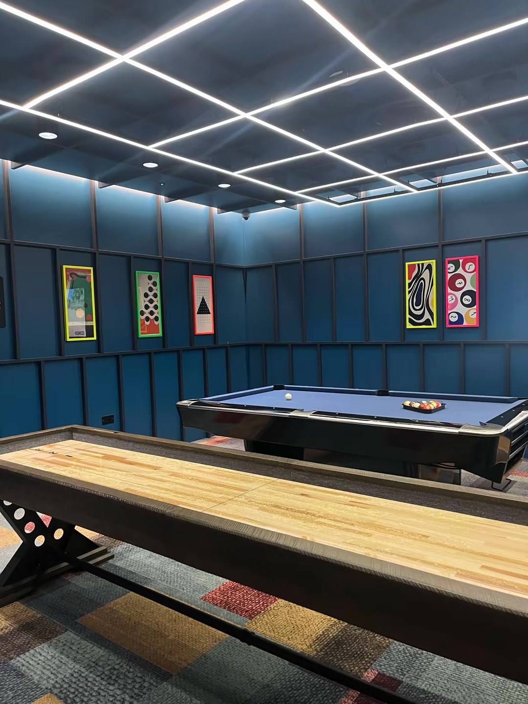 Games room with a pool table and shuffleboard table