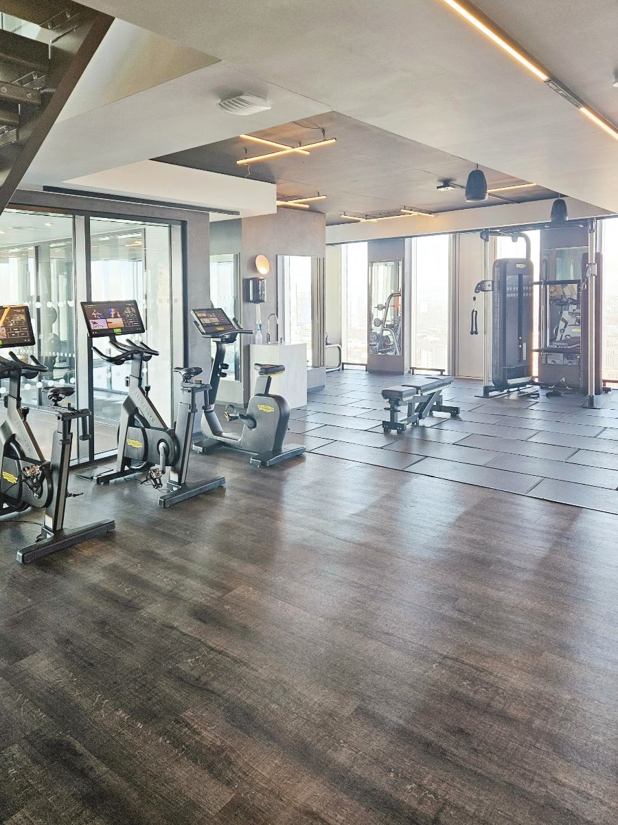 Gym with connected bikes, weights bench and strength-training equipment