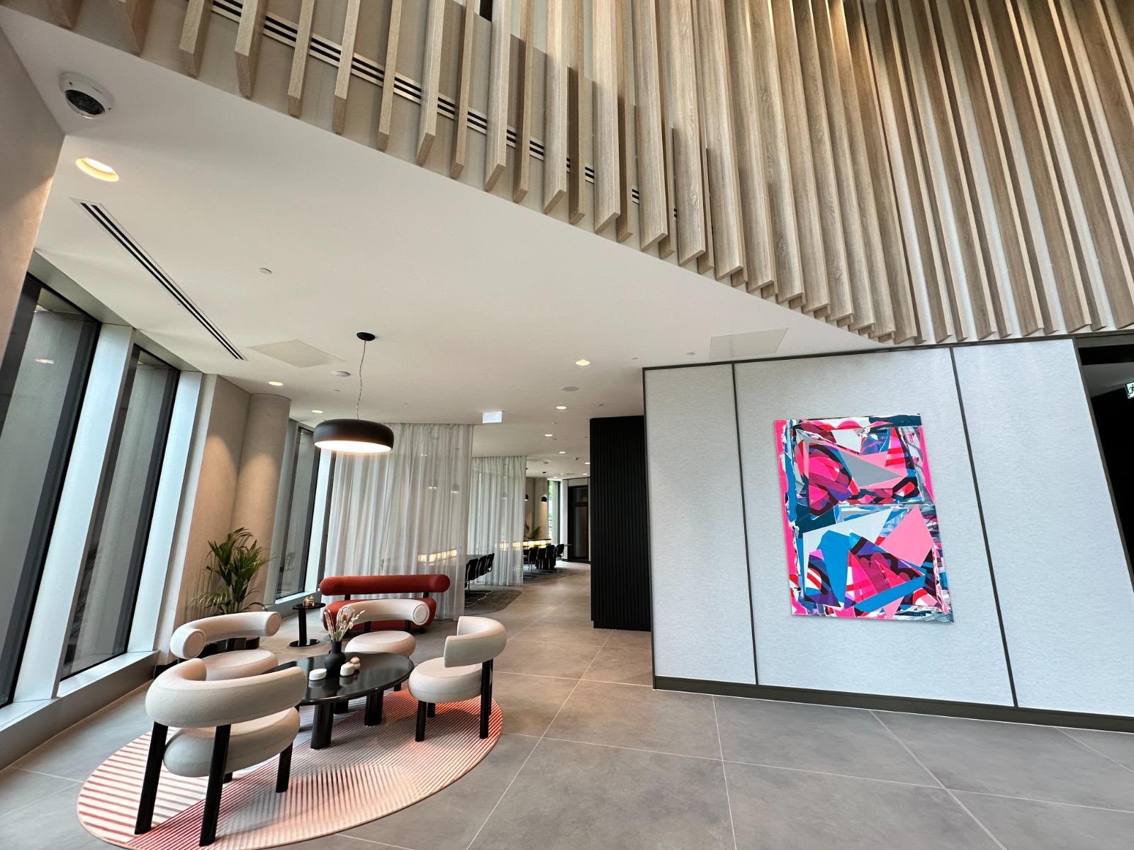 Residents' lounge seating with artwork and large windows
