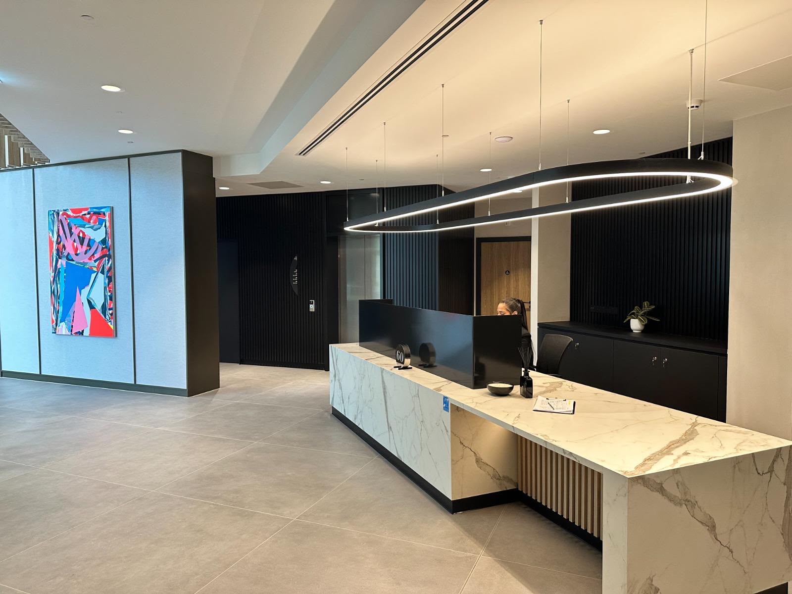 Concierge desk with marble-effect counter and feature lighting