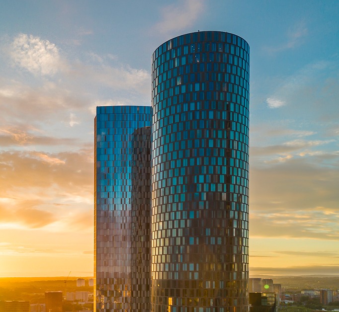 Three60's cylindrical tower against an evening sky