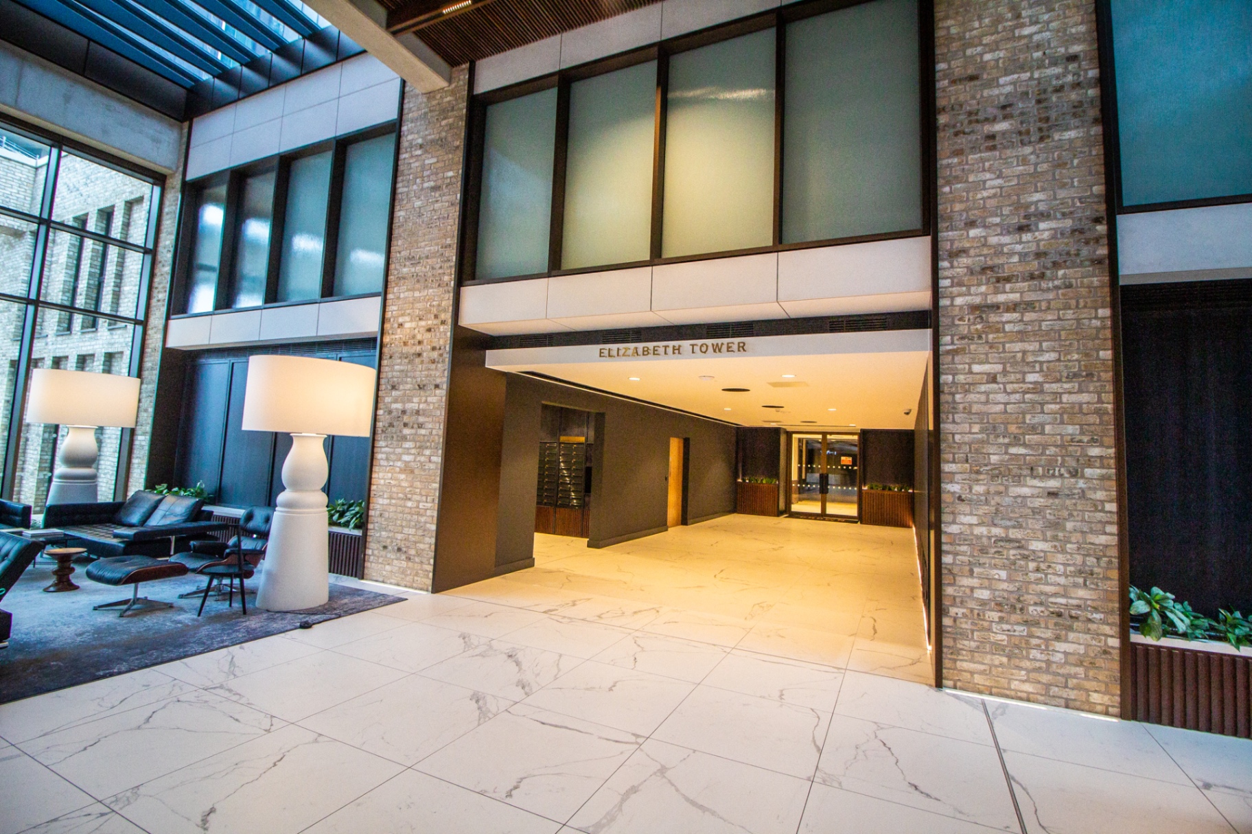 Entrance lobby with Elizabeth Tower signage, lounge seating and tall windows